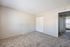 Bright and spacious bedroom featuring plush carpet, large closet, and neutral walls perfect for personalization.
