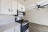 Modern kitchen with sleek stainless steel appliances, white cabinetry, and elegant wood flooring.