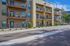 Modern apartment complex with spacious balconies, surrounded by lush greenery and offering scenic mountain views.