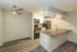 Modern kitchen with sleek appliances, an elegant countertop, and stylish flooring, perfect for contemporary living.