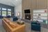 Inviting lounge area with modern decor, comfortable seating, a cozy fireplace, and large windows offering abundant natural light.