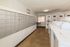 Modern apartment amenities featuring a bright, clean laundry room with ample washers and dryers alongside secure mailboxes, ideal for convenience and ease.