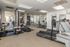 Contemporary fitness center with state-of-the-art exercise equipment, including treadmills and weight machines, in a bright and inviting space.