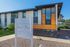 Contemporary exterior view of Oakwood Bend, showcasing modern architectural design with wood accents and lush landscaping.