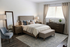 Elegant bedroom featuring a cozy bed with plush pillows, soft lighting, chic furniture, and a large window with flowing curtains.