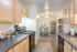 Modern kitchen with elegant wooden cabinets, spacious countertops, and a cozy dining area with contemporary d&eacute;cor.