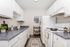 Bright, modern kitchen with sleek white cabinets, granite countertops, and elegant decor.