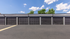 Modern apartment complex featuring a row of sleek, secure garage units under a clear blue sky.