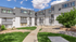 Charming apartment complex showcasing modern exterior with grey accents, lush green landscaping, and a welcoming pathway under a sunny sky.