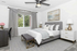 Luxurious bedroom with elegant decor, featuring a plush bed, modern furniture, and tranquil artwork, bathed in natural light.