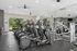 Modern fitness center with sleek cardio machines and vibrant outdoor views, offering a refreshing workout ambiance.