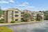 Charming apartment complex with classic architecture, spacious balconies, and lush landscaping, perfect for modern living.