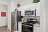 Modern kitchen with sleek stainless steel appliances, elegant white cabinetry, and stylish decorative accents.
