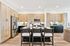 Modern kitchen with high-end stainless steel appliances, elegant wooden cabinetry, and a stylish island with seating for four.