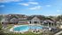 Luxurious apartment complex with a stunning outdoor pool area, modern architecture, and vibrant landscaping under a clear blue sky.