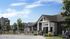 Charming apartment complex with modern leasing office, lush greenery, and inviting outdoor spaces.