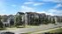 Modern apartment complex with elegant architecture, spacious balconies, and lush green surroundings under a clear blue sky.
