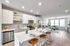 Modern open-concept kitchen and living area with sleek appliances, elegant decor, and abundant natural light.