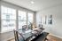 Bright and modern dining area with chic decor and large windows for abundant natural light.