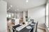 Bright open-concept living space with a modern kitchen island and elegant dining area, bathed in natural light.