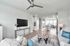 Bright and modern open-concept living area with elegant decor, featuring a cozy sitting space and contemporary kitchen.