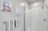 Modern bathroom with elegant glass shower, stylish wall art, and cozy towels enhancing the serene ambiance.