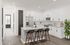Bright, modern kitchen with sleek white cabinetry, a large island with granite countertops, and stylish bar stools, accented by hardwood floors and natural light.