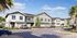 Charming suburban street with modern two-story townhouses and vibrant landscaping under a clear blue sky.