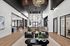 Luxurious modern lobby with high ceilings, elegant decor, and ample natural light, featuring stylish seating and a contemporary chandelier.