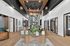 Elegant apartment lobby showcasing modern design with high ceilings, natural wood accents, and chic lighting fixtures, creating a welcoming atmosphere.