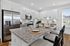 Modern kitchen with granite countertops, stainless steel appliances, and elegant dining setup, ideal for entertaining.