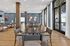 Modern dining area with elegant wooden furniture, large windows for natural light, and stylish decor creating a welcoming ambiance.