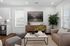 Contemporary living room featuring elegant decor, cozy seating, and abundant natural light with lush greenery.