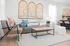 Bright and inviting living room with contemporary decor, plush seating, and elegant artwork creating a cozy atmosphere.