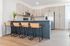 Modern kitchen with sleek cabinetry, stainless steel appliances, and stylish bar seating, perfect for entertaining.