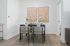 Chic dining space with elegant table setting and stylish artwork, perfect for intimate gatherings.