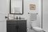 Contemporary bathroom featuring a stylish granite countertop, sleek black vanity, and modern decor.