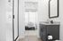 Elegant bathroom with granite countertop, black fixtures, and a view into a well-lit bedroom with modern decor.