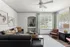 Bright and stylish living room with contemporary furniture, large windows, and elegant decor.