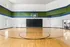 Spacious indoor basketball court with polished wooden floors and colorful walls.