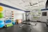 Bright and modern fitness room equipped with diverse workout equipment, including resistance bands, exercise balls, and weights.