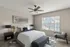 Luxurious bedroom with a stylish bed, modern artwork, and large window providing natural light.