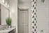 Stylish bathroom featuring a granite countertop, modern fixtures, and a chic shower curtain.