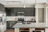 Sleek modern kitchen with dark cabinets, granite countertops, and stainless steel appliances.
