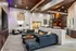 Chic modern living room with a spiral staircase, plush seating, and ambient lighting.