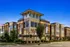 Charming evening view of an elegant apartment complex with large windows and warm lighting.