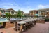 Stunning outdoor area with grilling stations, dining space, and a poolside view.