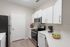 Contemporary kitchen with white cabinetry, stainless steel appliances, and elegant countertops.