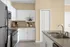 Sleek kitchen with stainless steel appliances, white cabinetry, and elegant countertops.