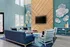 Chic living room with high ceilings, modern decor, and a large TV mounted on a wooden accent wall.